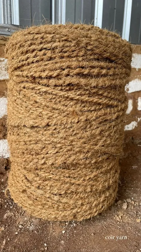 Coil of natural brown twisted coconut fiber rope