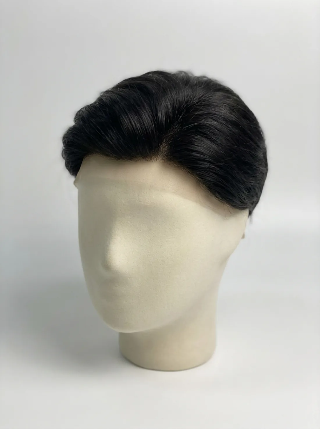 Men's human hair toupee styled on a mannequin head